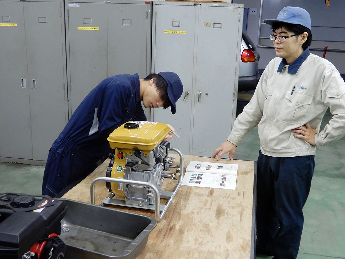 機械実習でエンジンの解体実習を行っている生徒。自動車整備士をめざしている。