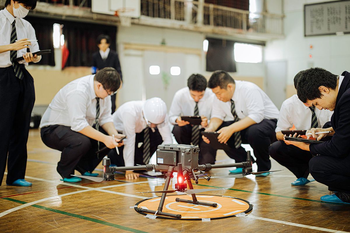 体育館で、空中ドローンの操縦練習を行う